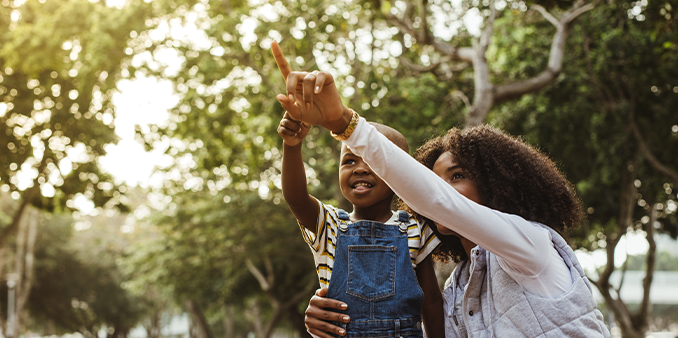 Mother and son spending time together in a park on sunny summer day - Nassau County Family Lawyer concept image