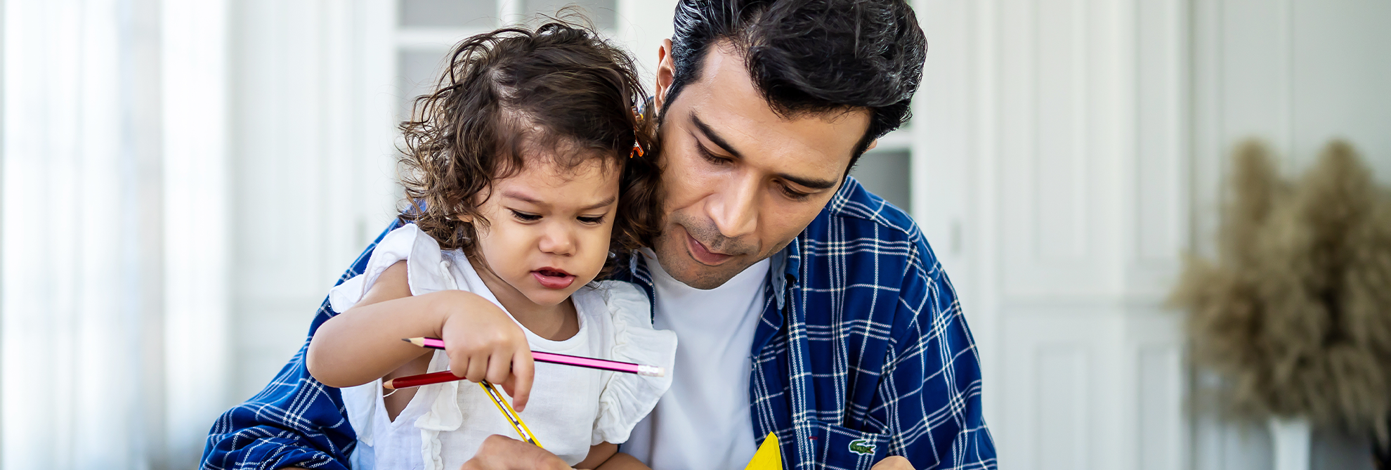 Portrait of young father teaching his cute little daughters study Excited smiling small child girl enjoying learning with pleasant dad at home Children education home schooling concept