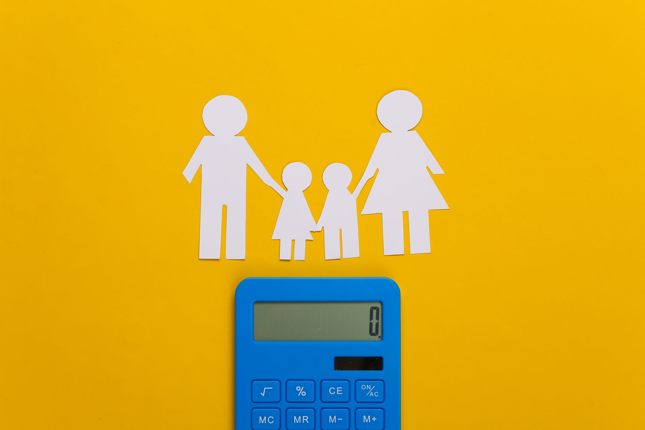 Paper family together with calculator on yellow background. Calculation of family expenses, budget