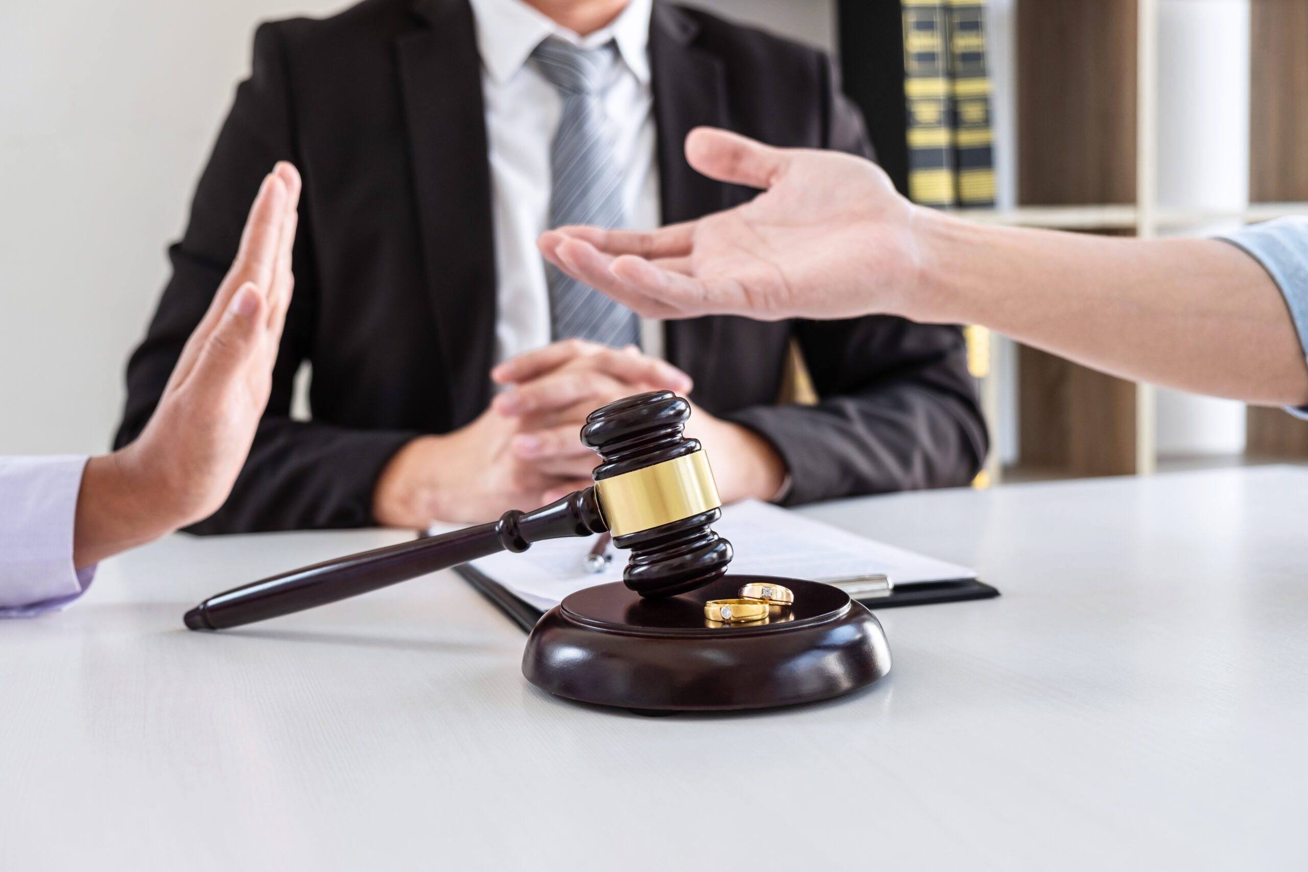 angry couple arguing telling their problems in the courthouse to getting divorced or premarital agreement in lawyers office, deciding on marriage divorce concept.