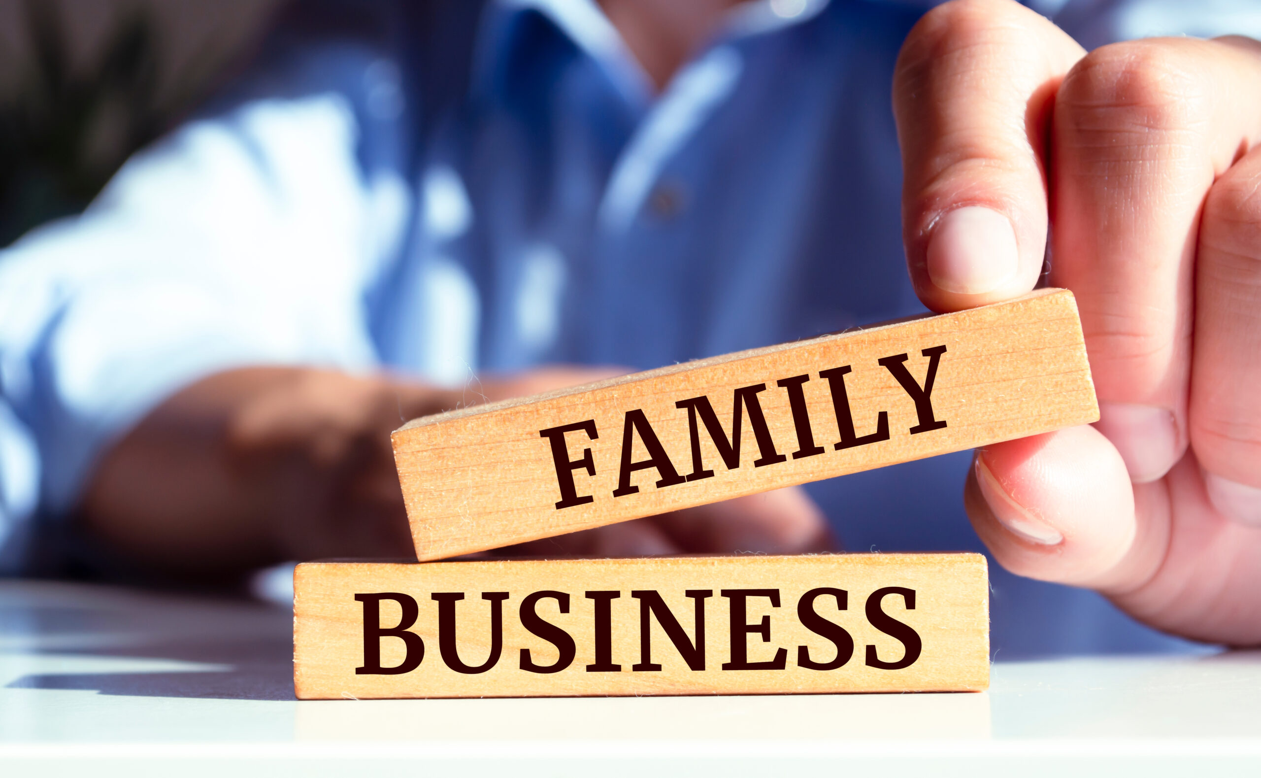 Closeup on businessman holding a wooden block with 